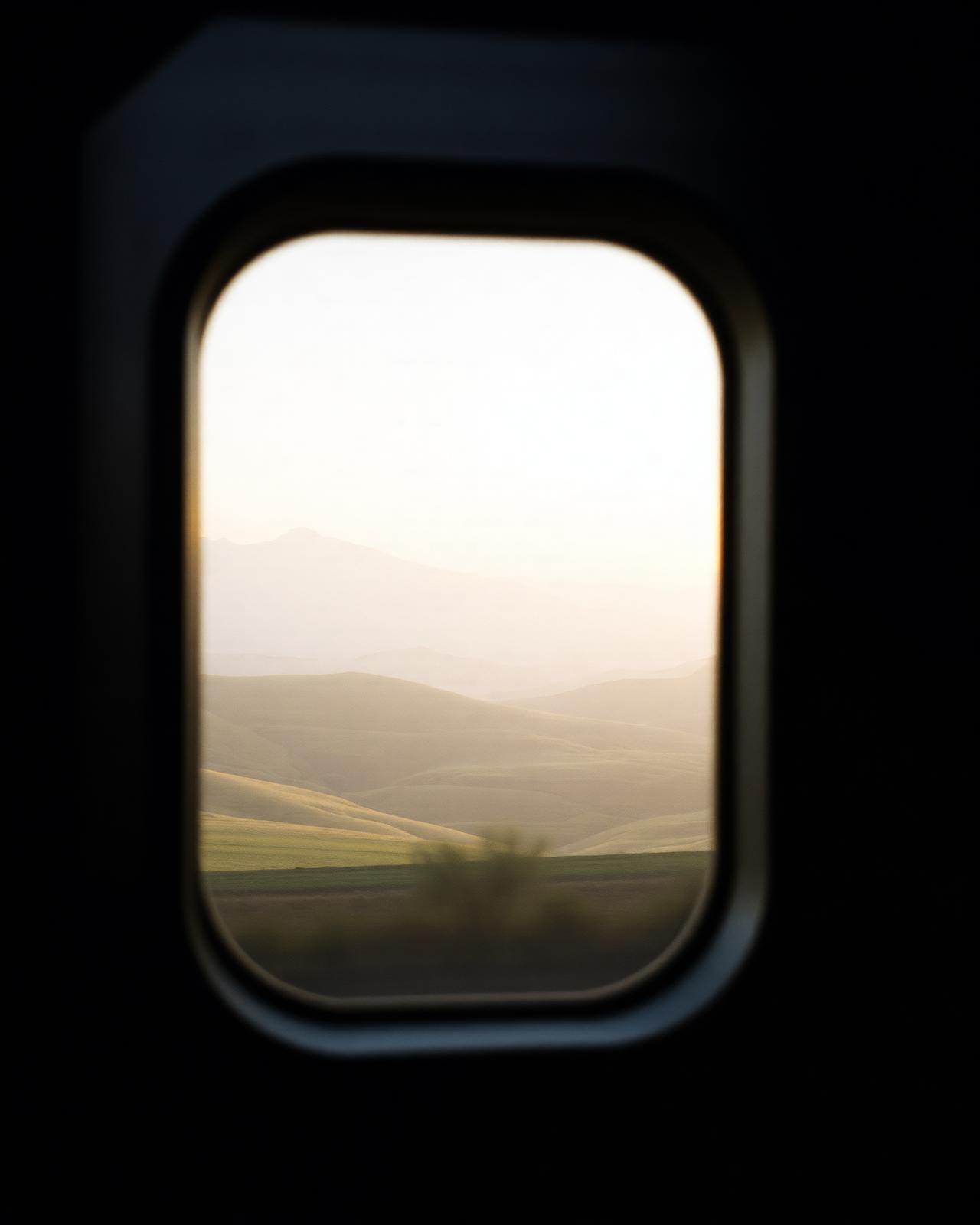 A still landscape viewed through a train window